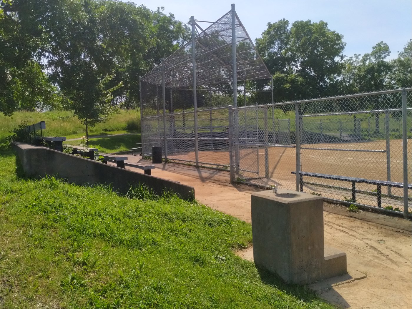 Things baseball parents say — empty tournament bleachers and batting cage at a baseball complex