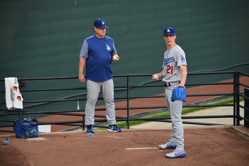 Los Angeles Dodgers pitcher Walker Buehler talking with a pitching coach during a 2019 bullpen session