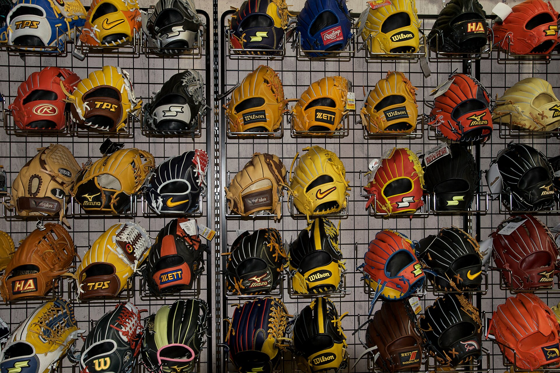 Wall of baseball gloves on display in a store