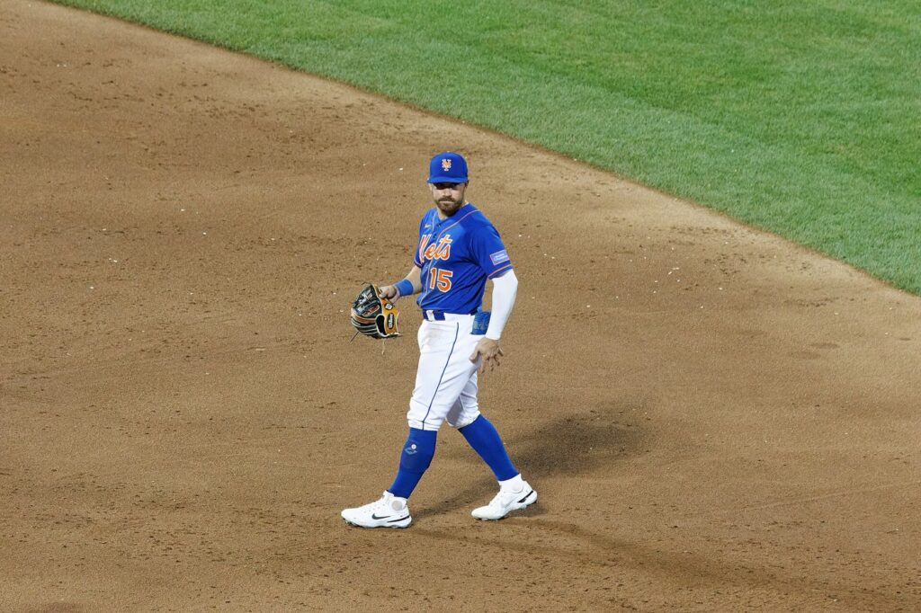 New York Mets infielder Danny Mendick with his glove on the infield dirt, July 29, 2023