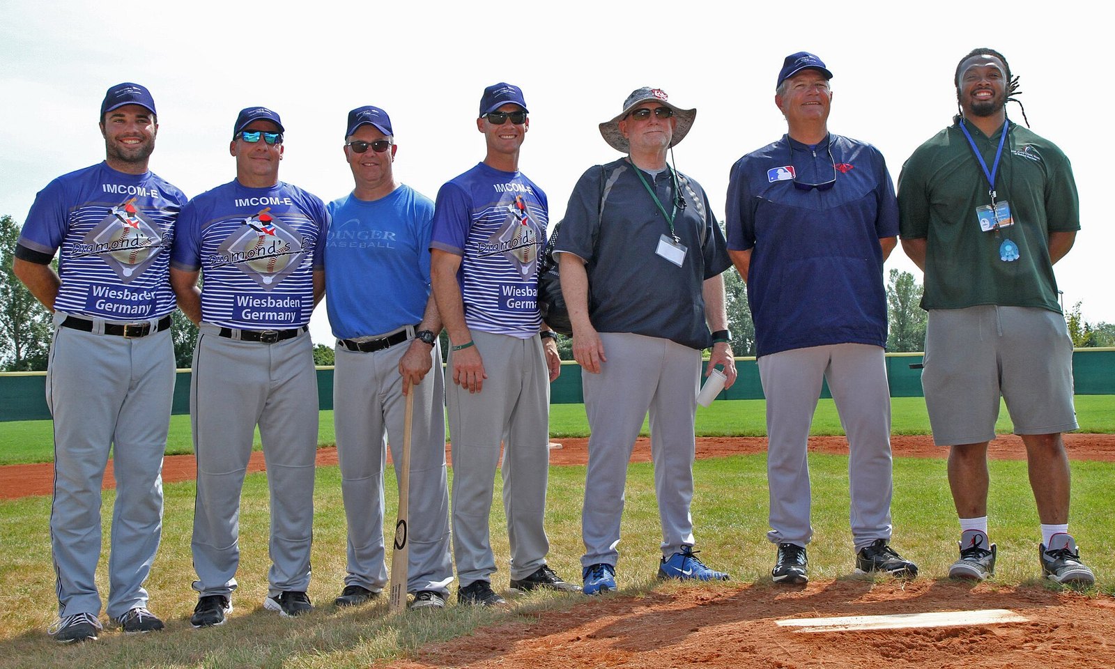Youth baseball camp coaching staff lined up on the field in Wiesbaden, Germany
