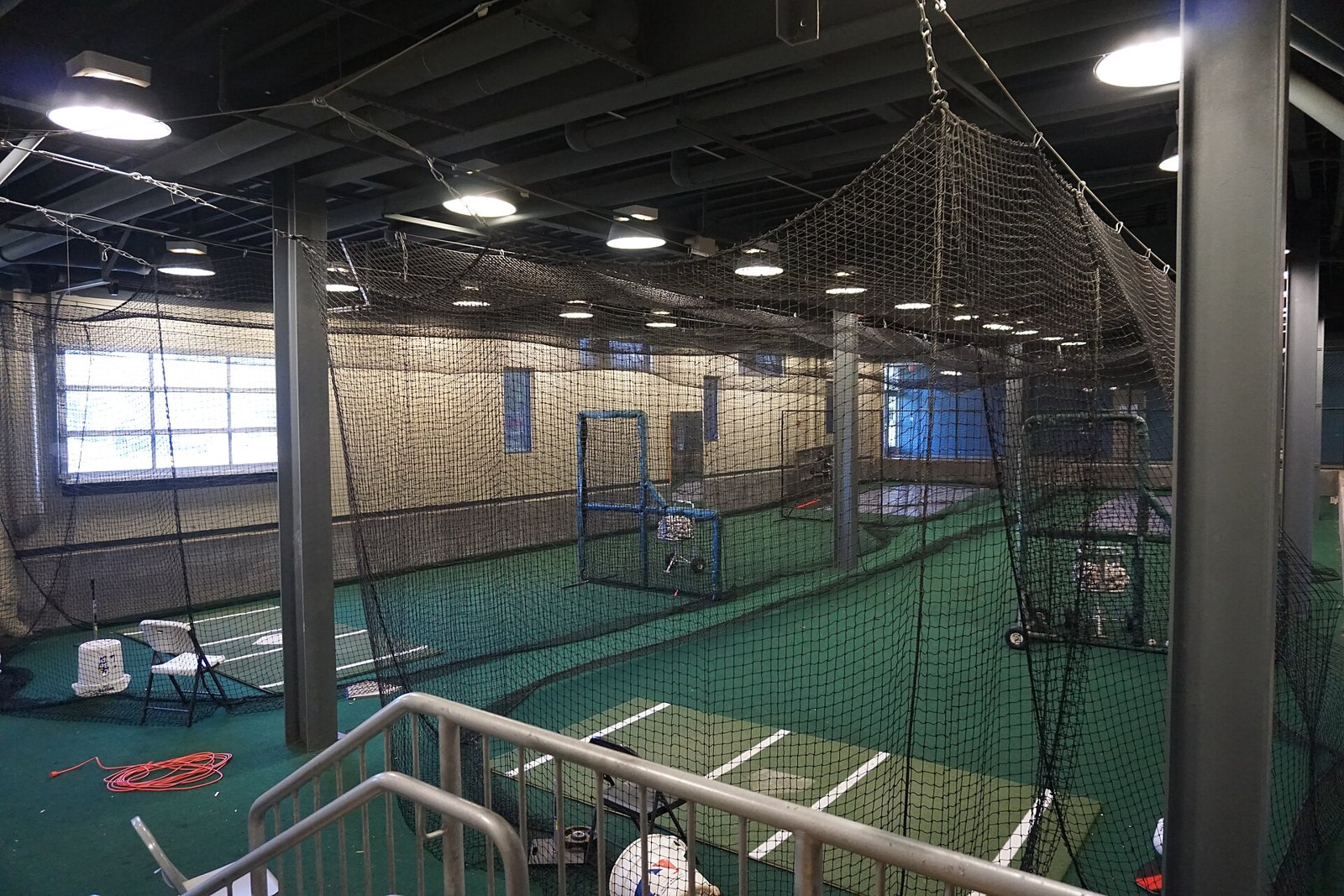 Indoor batting cages like those used in Frisco for winter youth baseball offseason training when daylight is short